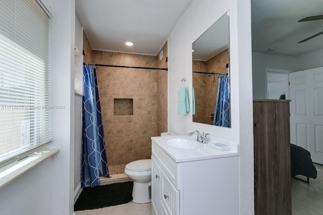 bathroom with tile patterned floors, vanity, toilet, and curtained shower