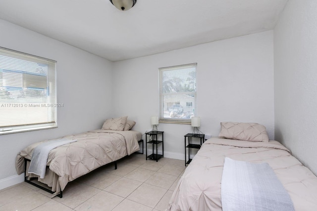 bedroom with light tile patterned floors