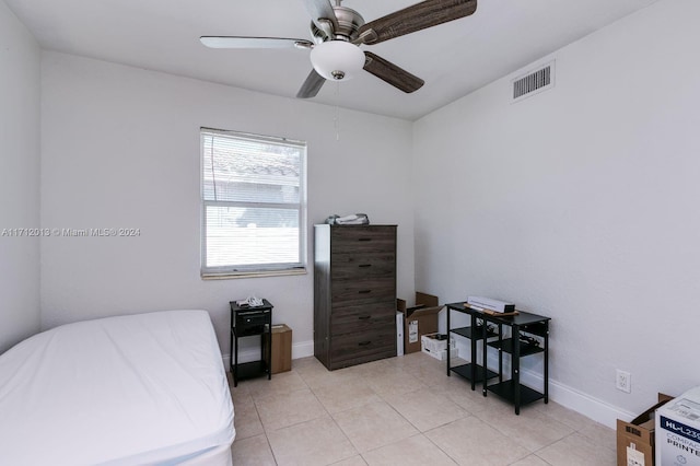 bedroom with ceiling fan and light tile patterned floors