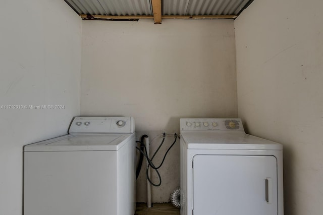 clothes washing area with washing machine and dryer