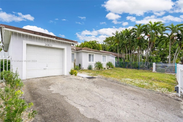 ranch-style house with a front lawn and a garage