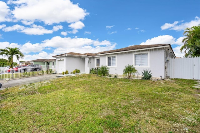 ranch-style home with a front yard and a garage