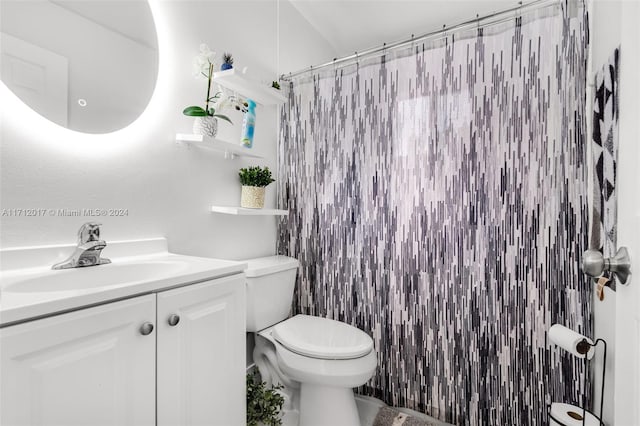 bathroom with vanity, curtained shower, and toilet