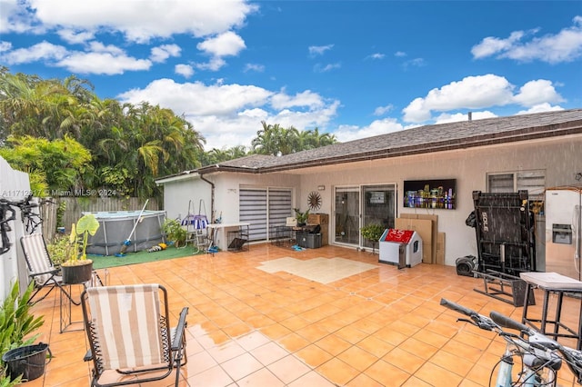 back of house featuring a patio and a pool