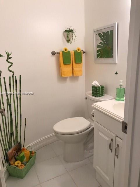 bathroom with tile patterned floors, vanity, and toilet