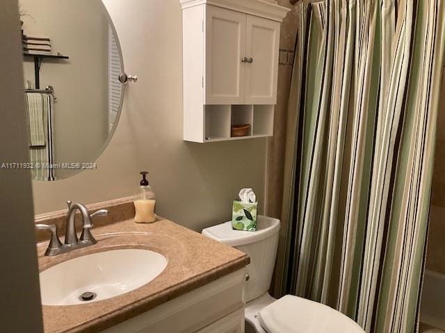 bathroom with vanity, toilet, and walk in shower