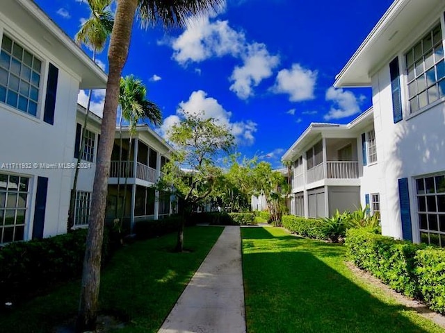 view of property's community with a lawn