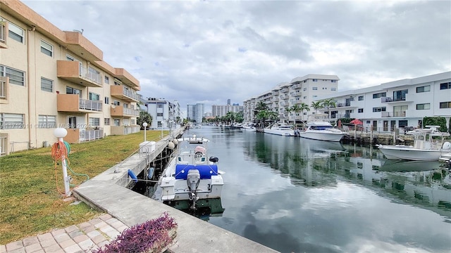 view of dock featuring a lawn and a water view