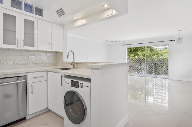 washroom featuring light tile patterned flooring, washer / dryer, and sink