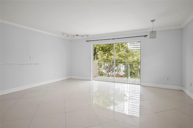 tiled empty room featuring ornamental molding