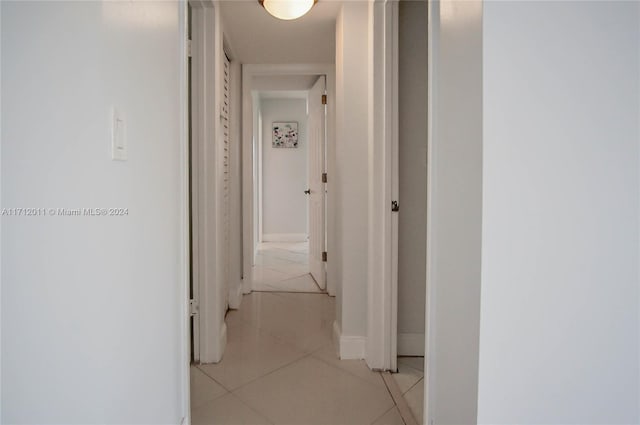 hall featuring light tile patterned floors