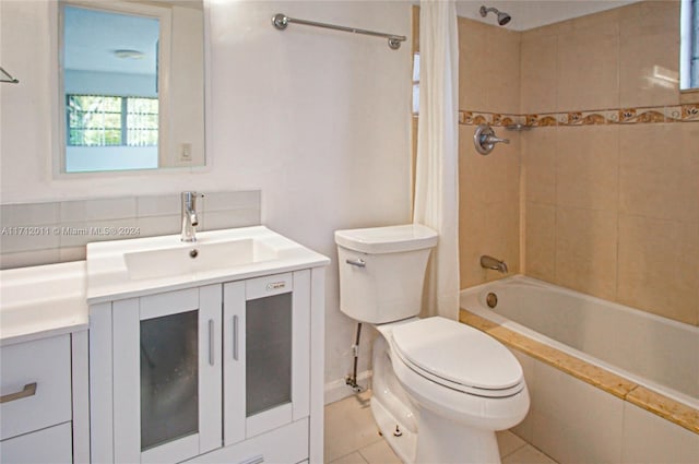 full bathroom with tile patterned floors, vanity, tiled shower / bath combo, and toilet