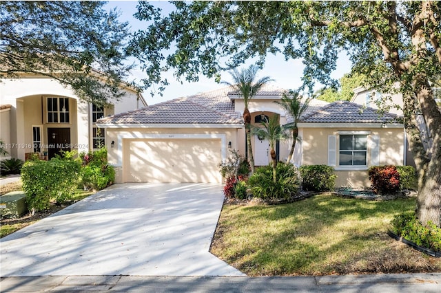 mediterranean / spanish house with a front lawn and a garage