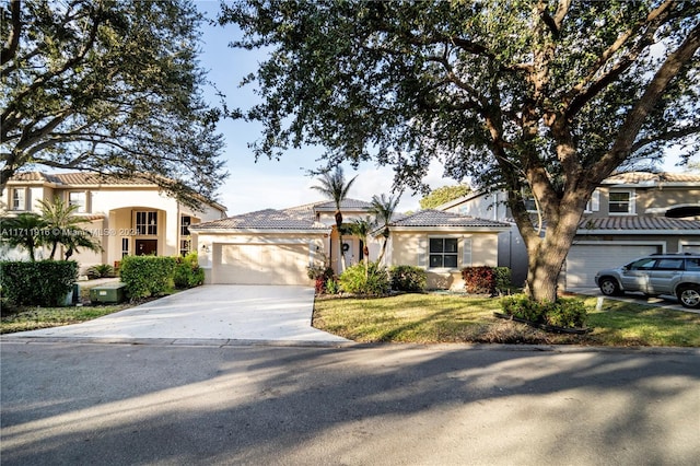 view of front of property featuring a garage and a front lawn