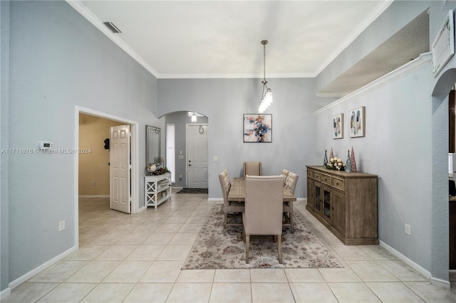 tiled dining room featuring crown molding