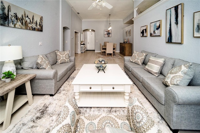 living room with ceiling fan, light tile patterned flooring, and crown molding