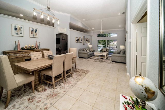 dining room with light tile patterned floors, vaulted ceiling, ceiling fan, and crown molding