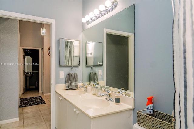 bathroom with tile patterned floors and vanity