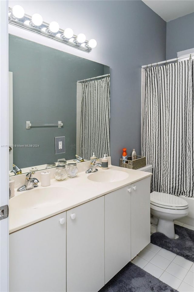 bathroom with tile patterned flooring, vanity, a shower with shower curtain, and toilet