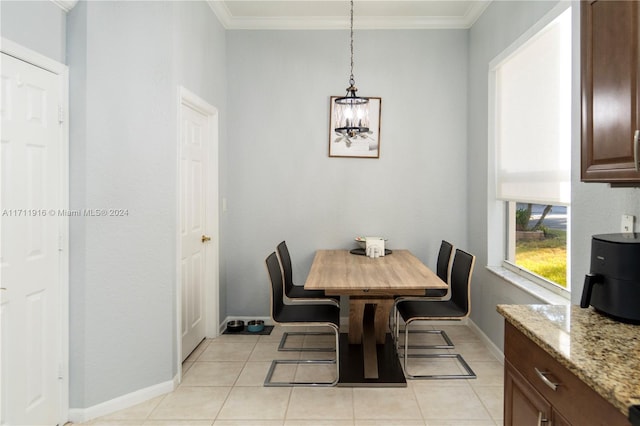 dining room with light tile patterned floors and ornamental molding