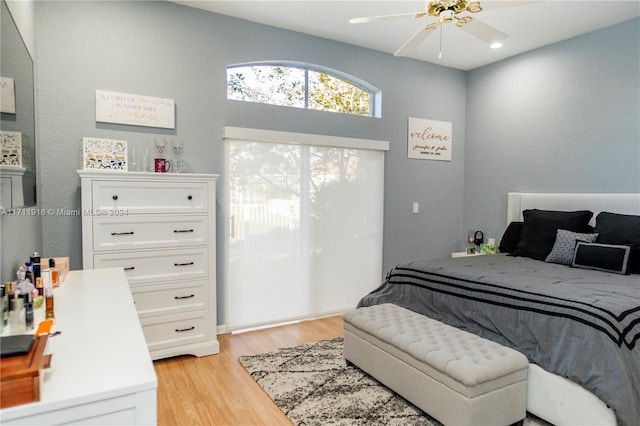 bedroom with light hardwood / wood-style floors and ceiling fan