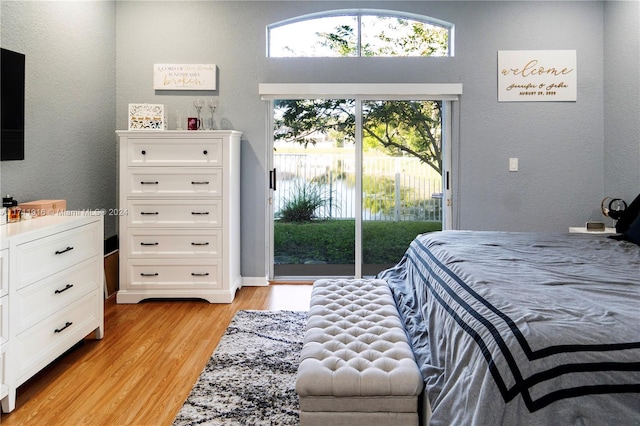 bedroom with light wood-type flooring and access to outside