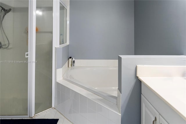 bathroom featuring tile patterned flooring, vanity, and independent shower and bath