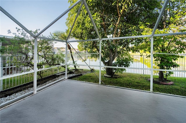 unfurnished sunroom featuring a water view