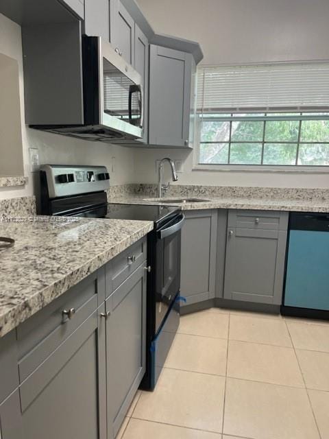 kitchen with gray cabinets, appliances with stainless steel finishes, and sink