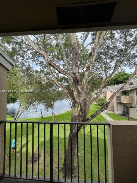 view of yard featuring a balcony and a water view