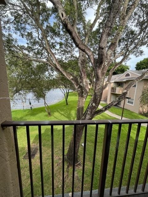 view of yard with a water view and a balcony