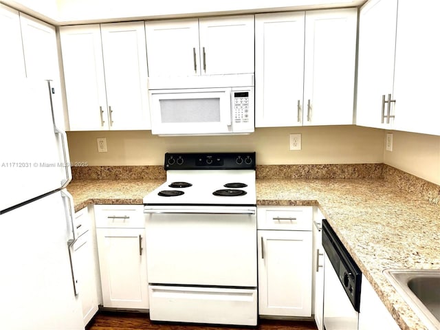 kitchen featuring white appliances and white cabinetry