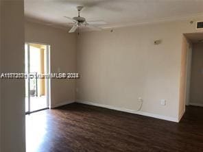 spare room with ceiling fan and dark wood-type flooring