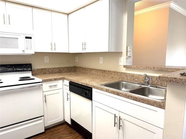 kitchen featuring dark wood-type flooring, white appliances, white cabinetry, and a sink