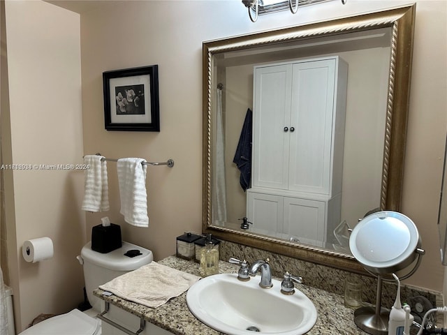 bathroom featuring vanity and toilet