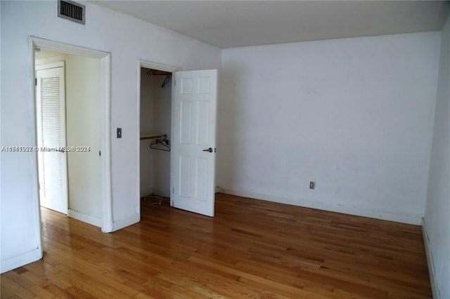 unfurnished bedroom featuring hardwood / wood-style flooring