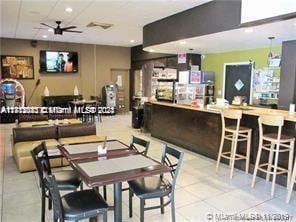 dining area with ceiling fan and light tile patterned floors