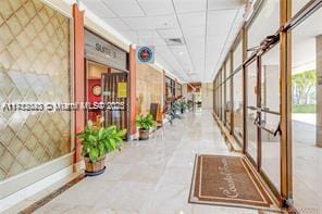 corridor featuring a paneled ceiling