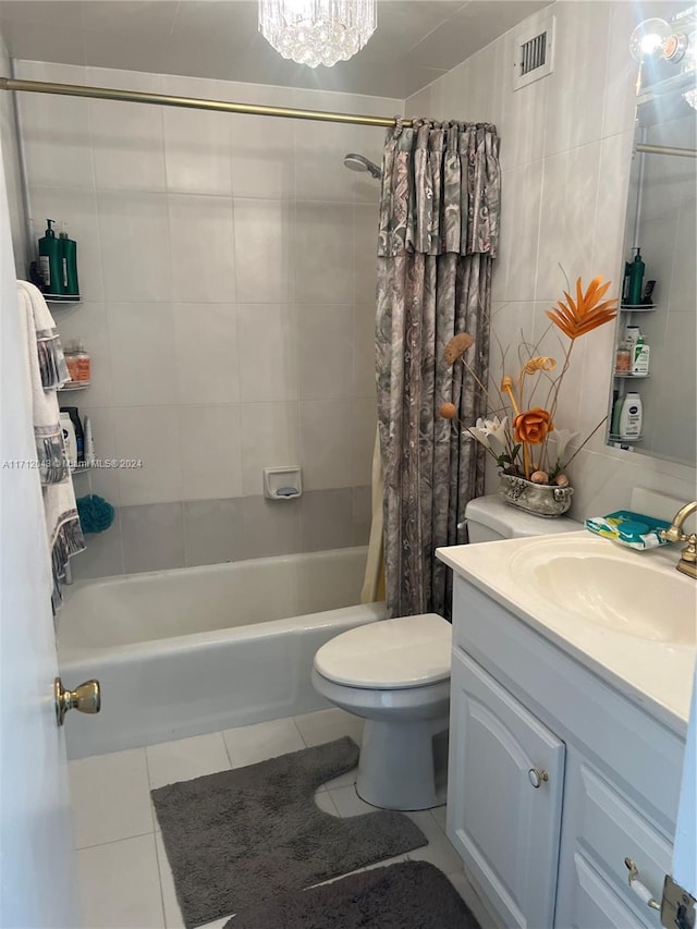 full bathroom with shower / bath combination with curtain, tile patterned floors, vanity, tile walls, and toilet