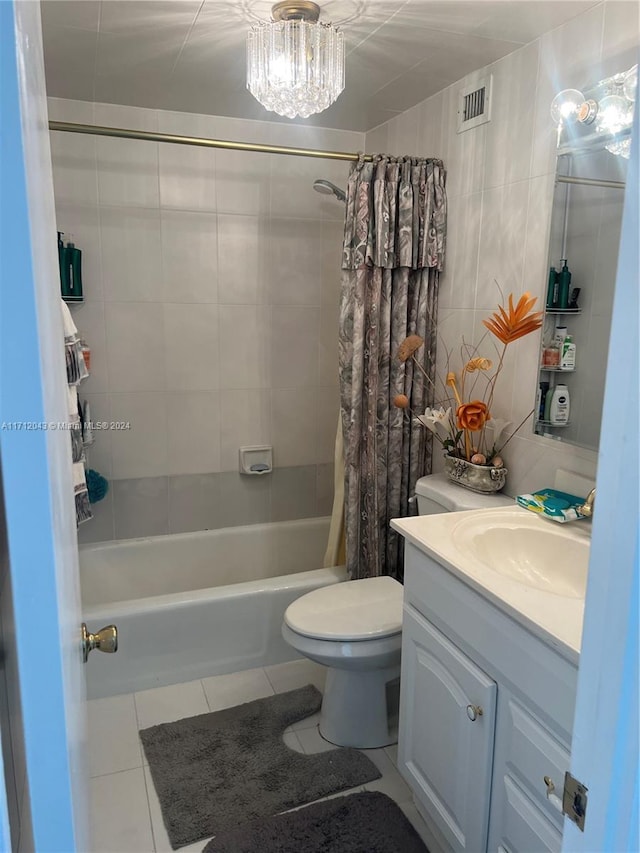 full bathroom featuring vanity, tile patterned floors, shower / bath combination with curtain, toilet, and tile walls