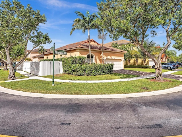 view of front of home featuring a front yard and a garage