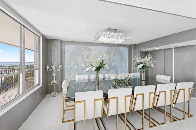 tiled dining area featuring a notable chandelier