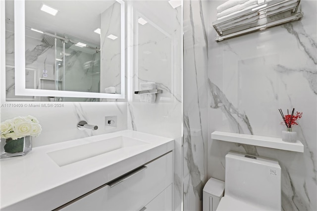 bathroom with an enclosed shower, vanity, and toilet