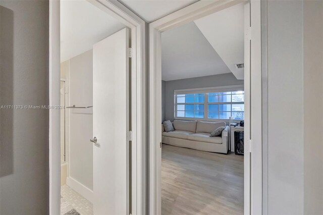 hallway with light hardwood / wood-style flooring