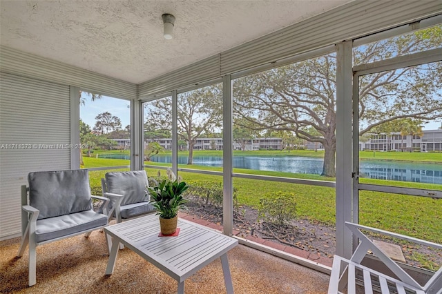 sunroom / solarium featuring a water view