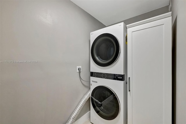 clothes washing area with stacked washer / drying machine