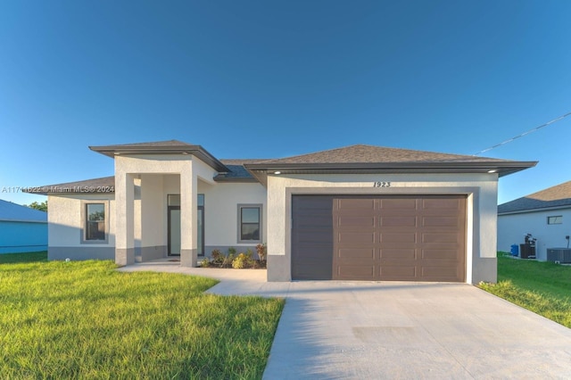 view of front of property with a garage and a front yard