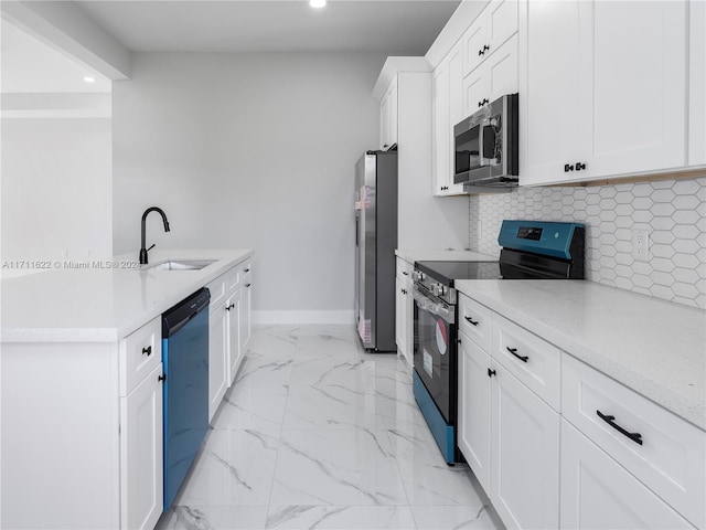 kitchen with light stone countertops, sink, stainless steel appliances, tasteful backsplash, and white cabinets