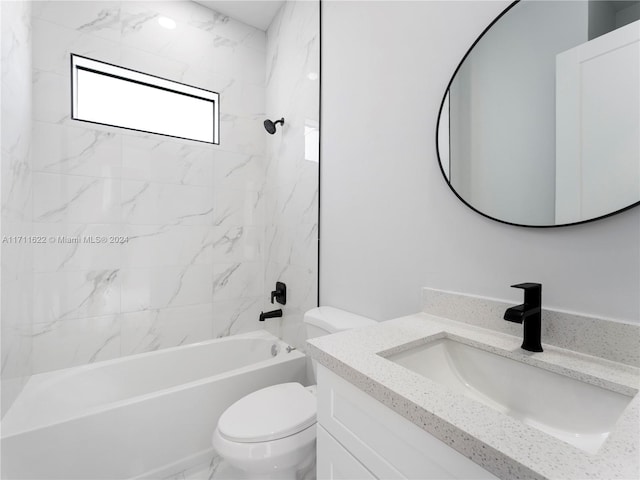 full bathroom with vanity, tiled shower / bath combo, and toilet