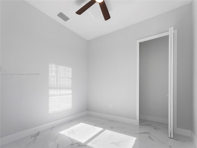 empty room with ceiling fan and lofted ceiling